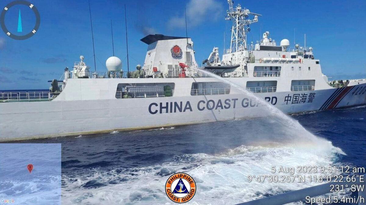 A Chinese coast guard ship uses water canons on a Philippine Coast Guard ship near the Philippine-occupied Second Thomas Shoal, South China Sea, as they blocked it's path during a re-supply mission on Aug. 5, 2023. (Philippine Coast Guard via AP)