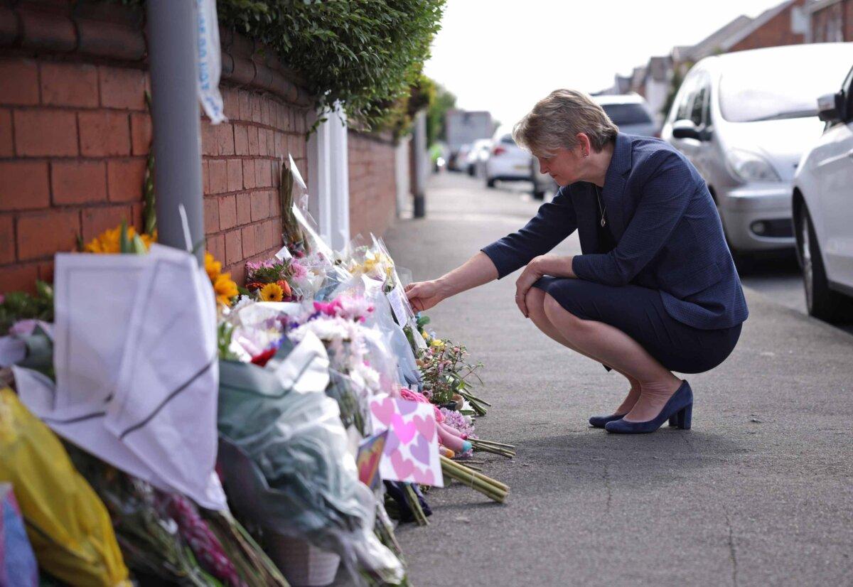 Home Secretary Yvette Cooper reads messages left on flowers near the scene in Southport, England, on July 30, 2024. (James Speakman/PA)