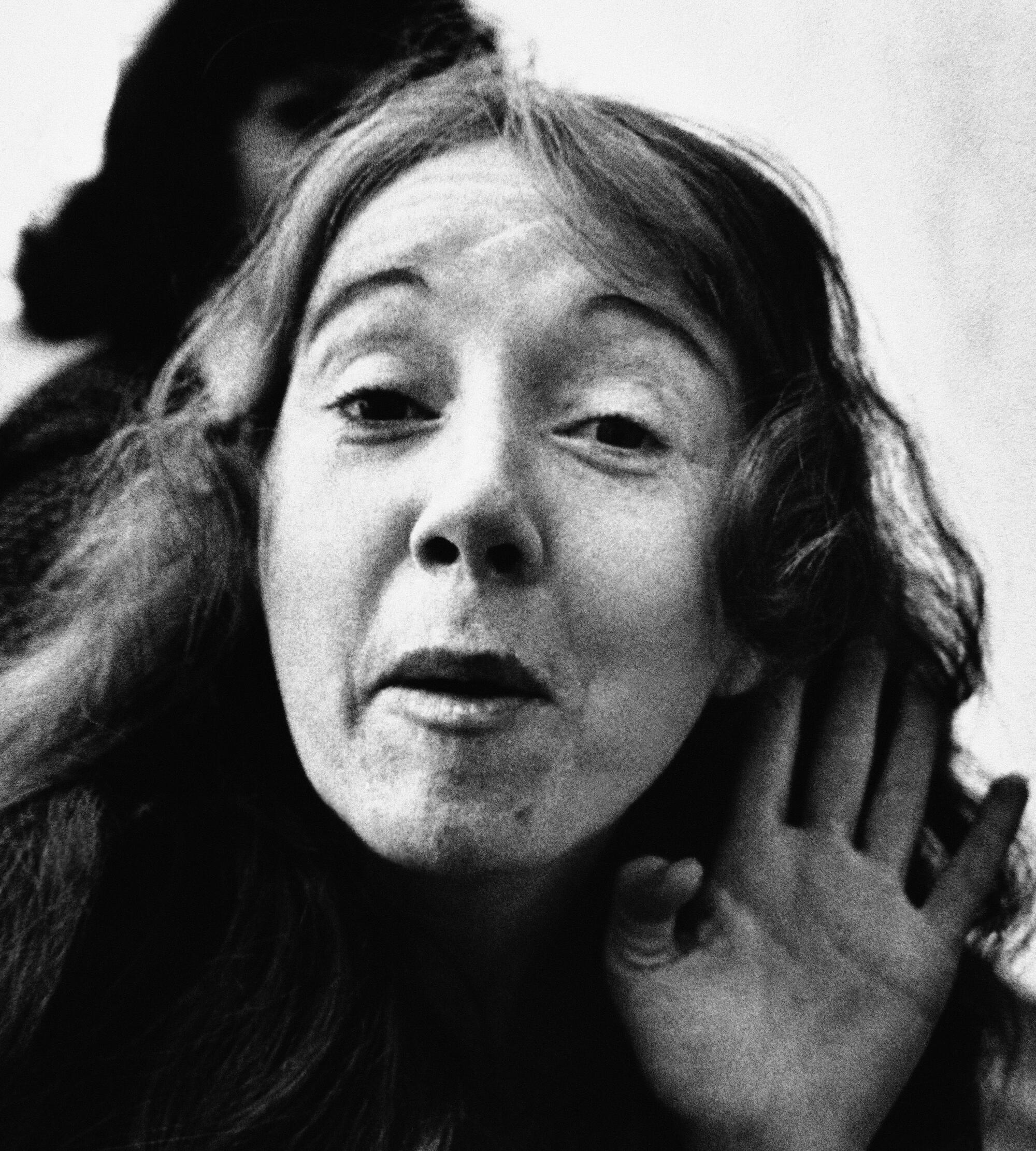 Lynette "Squeaky" Fromme waves to a camera at the federal courthouse.