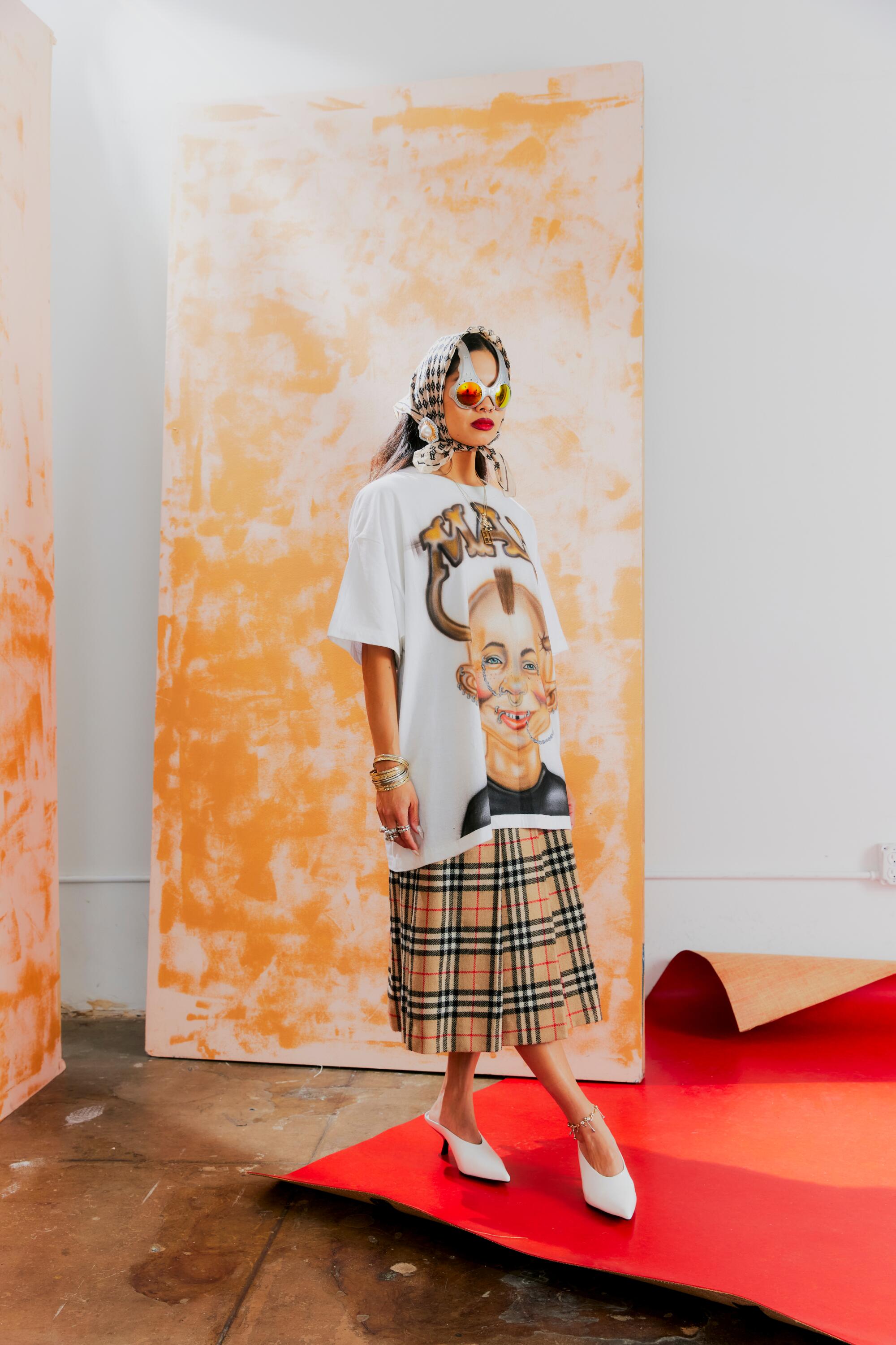 Stylist poses in Over the Top glasses and white kitten heels.