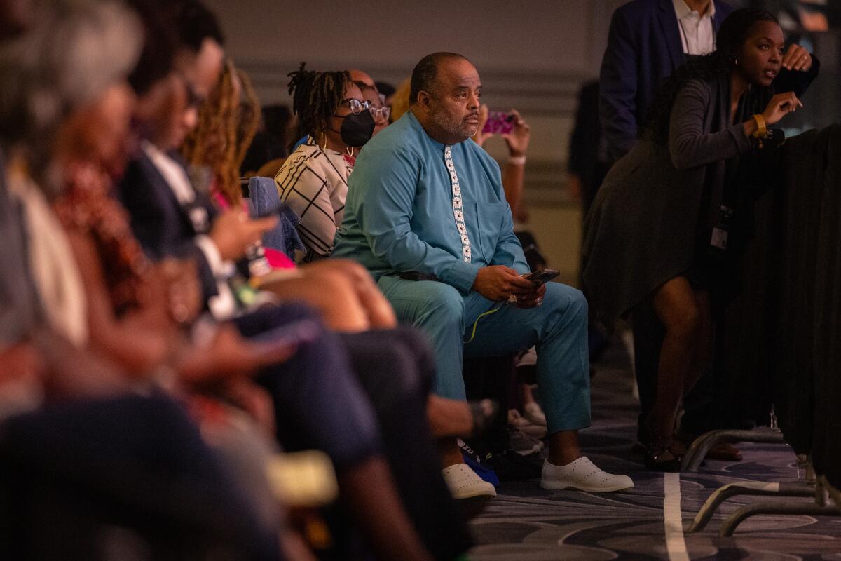 Journalist Roland Martin listens as former President Trump speaks in Chicago.