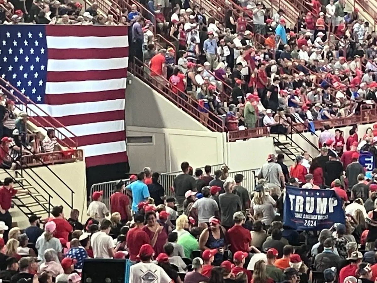 Fans of former President Donald Trump await his arrival during a campaign rally at the New Hollard Arena in Harrisburg, Pa., on July 31, 2024. (Janice Hisle/The Epoch Times)