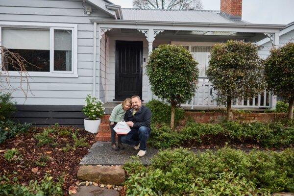 A father and daughter receive food delivery through a DoorDash drone on July 17, 2024. (Courtesy of DoorDash Australia)