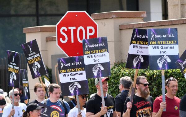 SAG-AFTRA union video game performers strike outside Warner Bros. Games, part of the Global Streaming and Interactive Entertainment unit of Warner Bros. Discovery, in Burbank, Calif., on Aug. 1, 2024. (Chris Delmas/AFP via Getty Images)