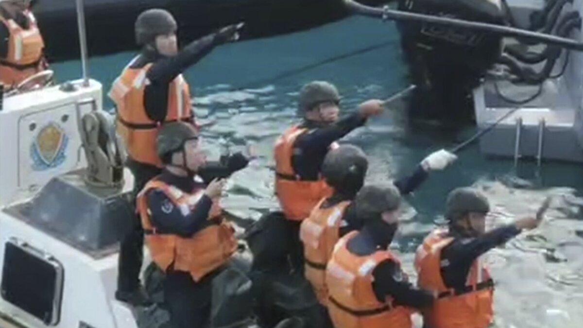 Chinese Coast Guard hold knives and machetes as they approach Philippine troops on a resupply mission in the Second Thomas Shoal at the disputed South China Sea on June 17, 2024. (Armed Forces of the Philippines via AP)