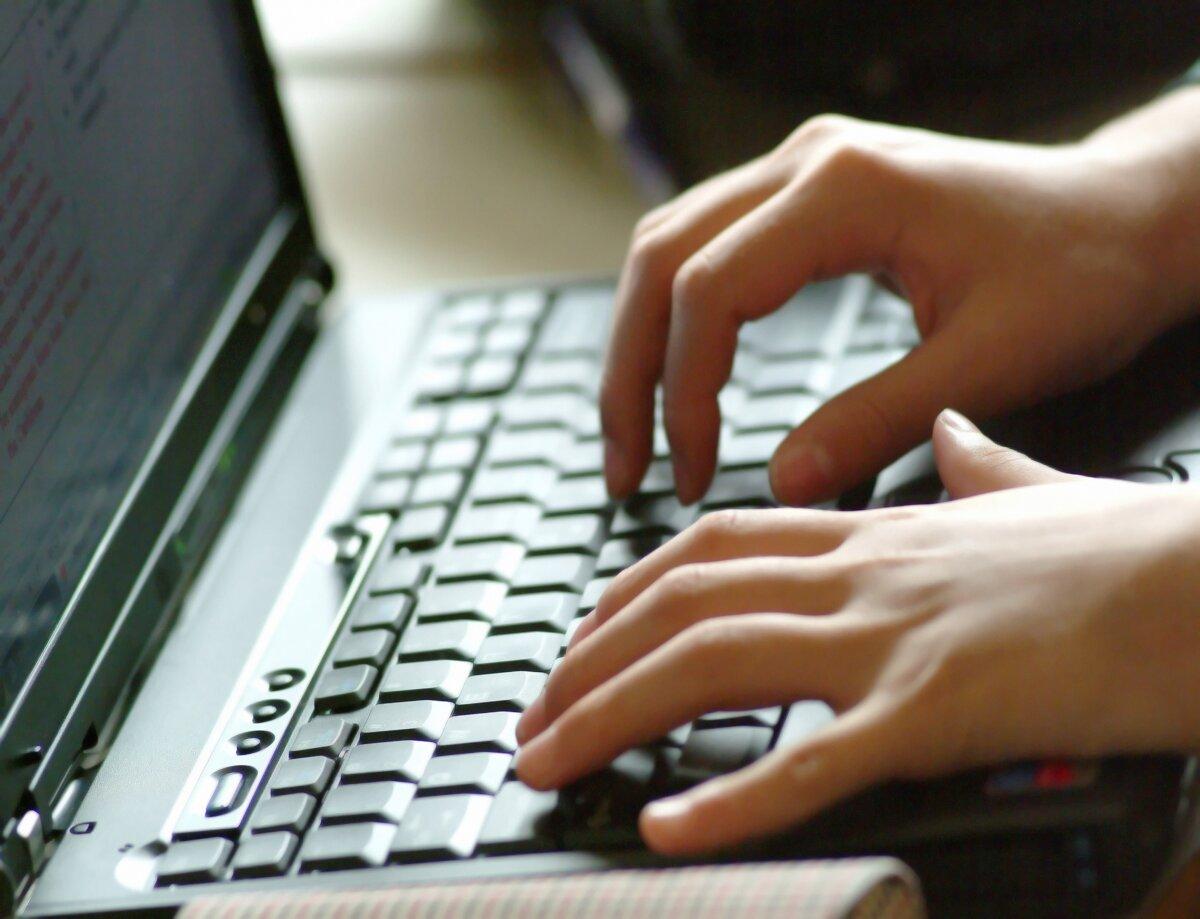 A person types on a keyboard, in a file photo. (The Epoch Times)