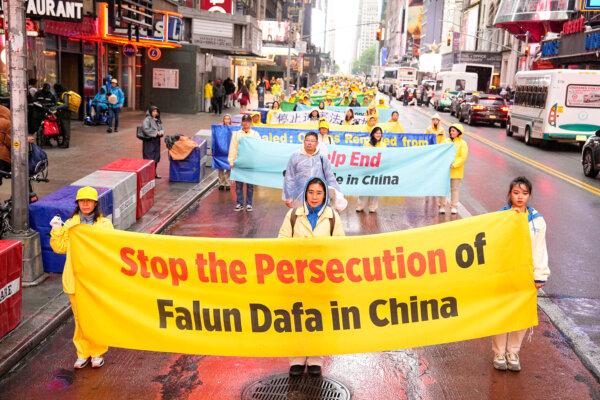 Falun Gong practitioners take part in a parade to celebrate World Falun Dafa Day while calling for an end of the persecution in China, in New York City, on May 10, 2024. (Larry Dye/The Epoch Times)