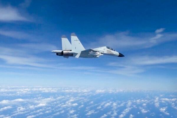 A Chinese People’s Liberation Army Navy J-11 fighter pilot performs an unsafe maneuver during an intercept of a U.S. Air Force RC-135 aircraft, which was conducting routine operations over the South China Sea in international airspace, on Dec. 21, 2022, in a still from video footage. (Courtesy of U.S. Indo-Pacific Command/Screenshot via The Epoch Times)