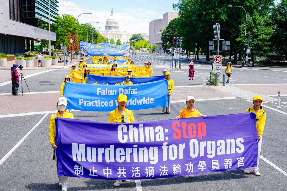 Falun Gong practitioners march during a parade calling for the end of the Chinese Communist Party’s 25 years of ongoing persecution of Falun Gong practitioners in China at the National Mall in Washington on July 11, 2024. (Larry Dye/The Epoch Times)