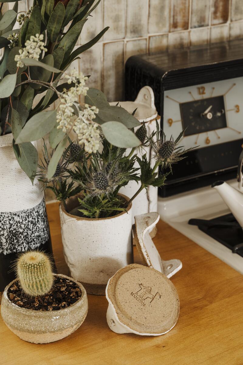 Pottery and planters next to a stove in the kitchen