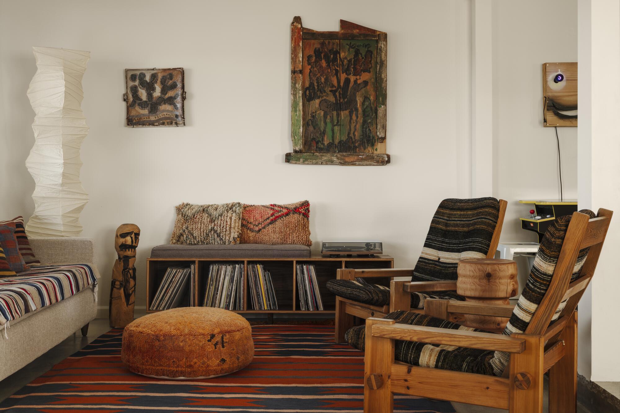 A living room with wooden furnishings, records and art 