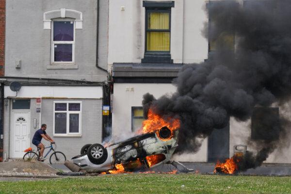 A car burns after being overturned during an anti-immigration protest in Middlesbrough, England, on Aug. 4, 2024. (Owen Humphreys/PA Wire)