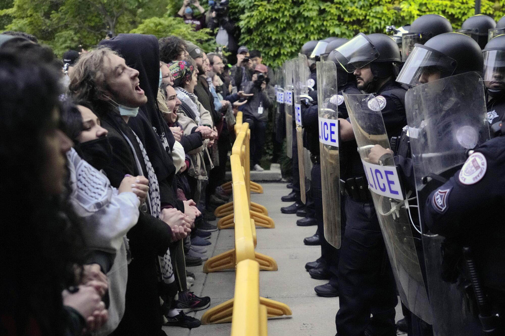 Pro-Palestinian protesters face off with University of Chicago police.