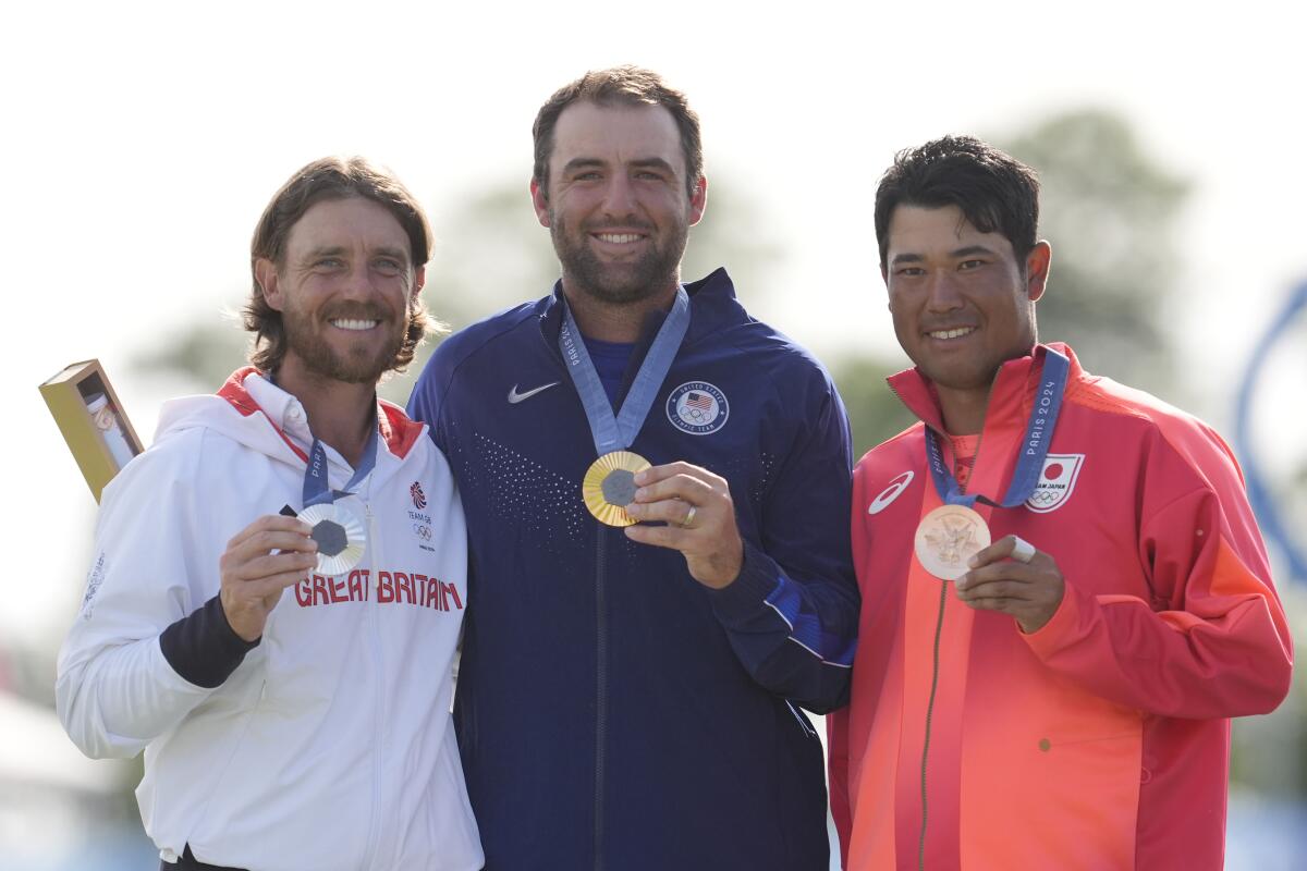 Scottie Scheffler, Tommy Fleetwood and Hideki Matsuyama pose with their Olympic medals