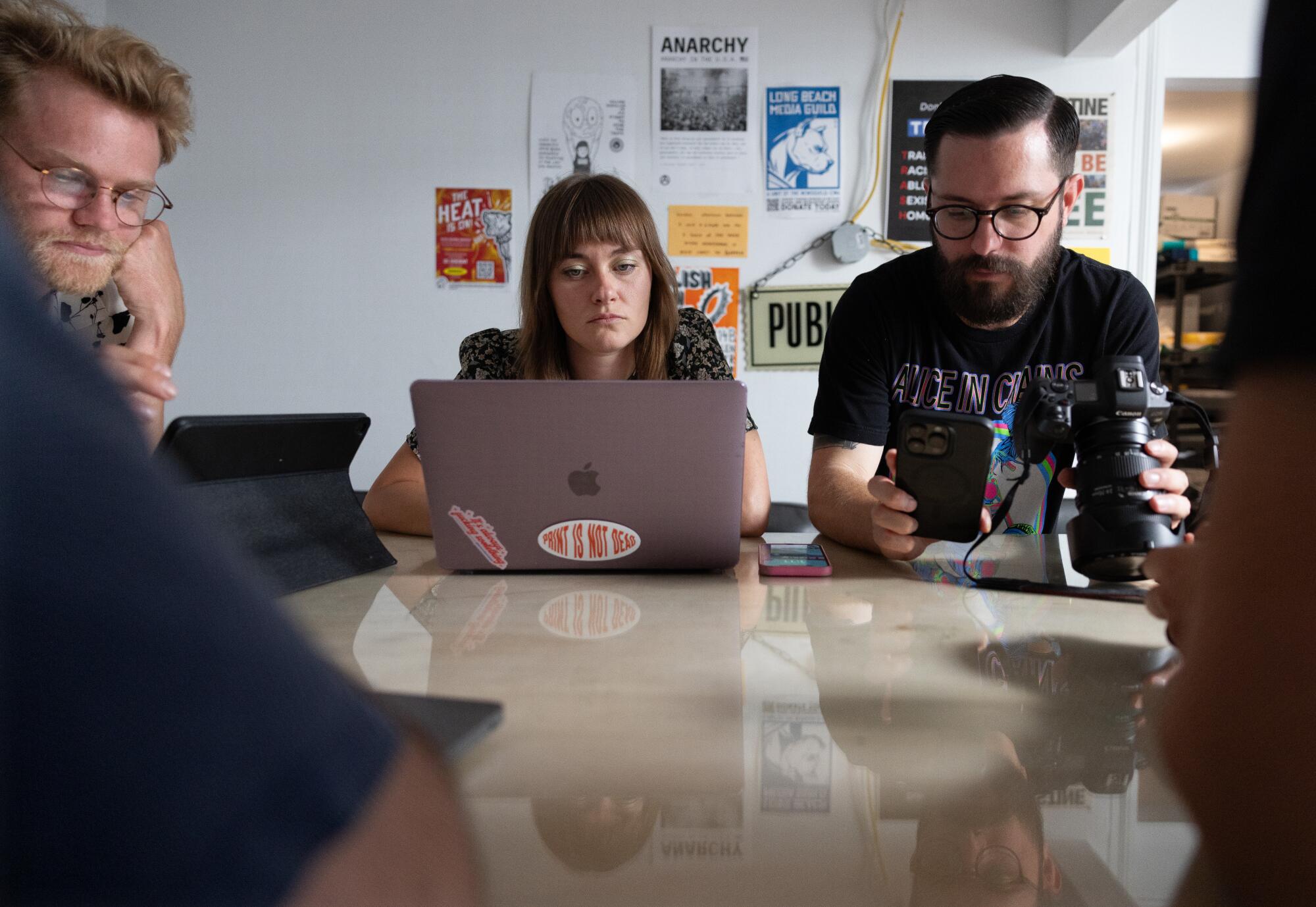 People sit around a table in an office.