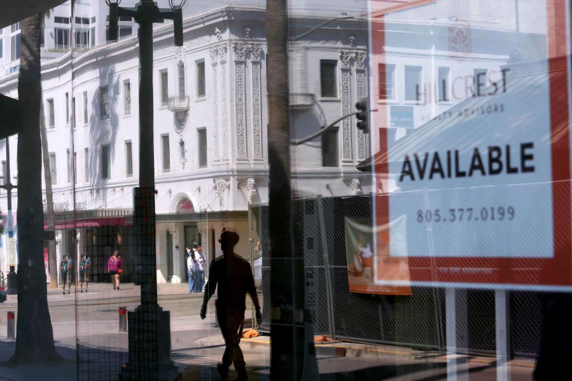 Signs in a store window warn "Silent alarm notifies police dispatch."