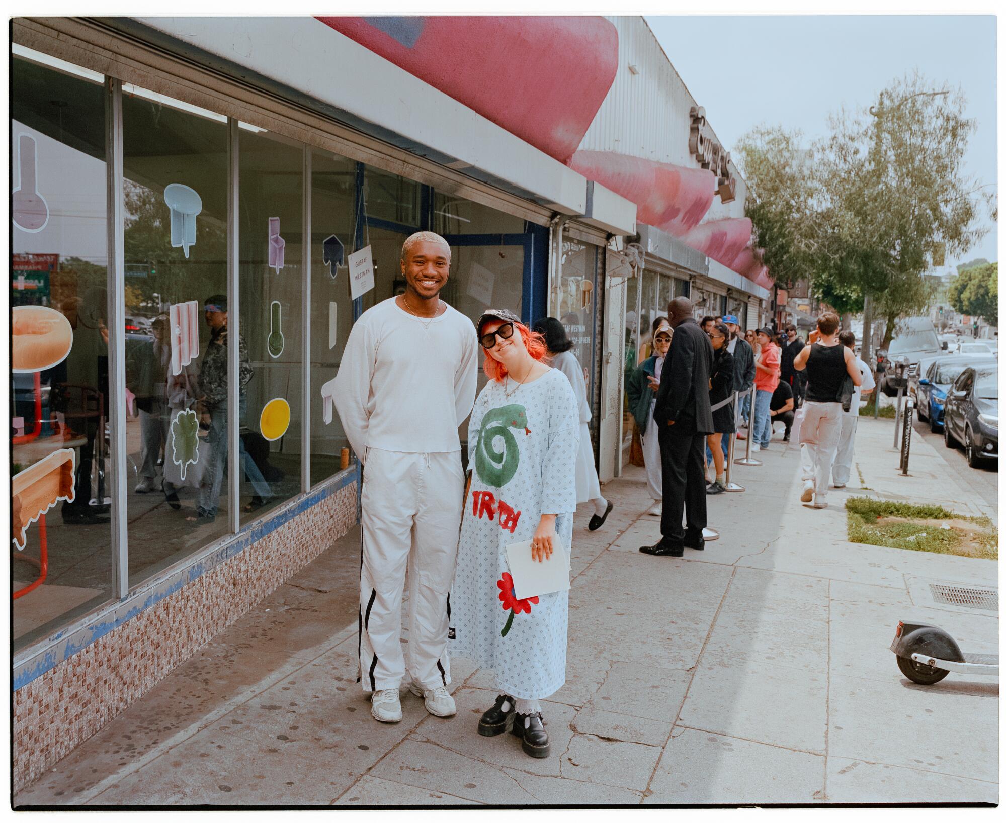 Two people pose beside a line.