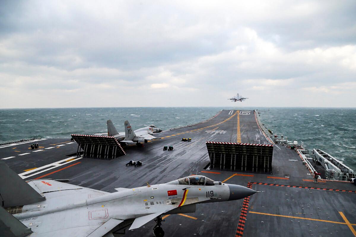 Chinese J-15 fighter jets launch from the deck of the 'Liaoning' aircraft carrier during military drills in the Yellow Sea, off China's east coast, on Dec. 23, 2016. (STR/AFP via Getty Images)