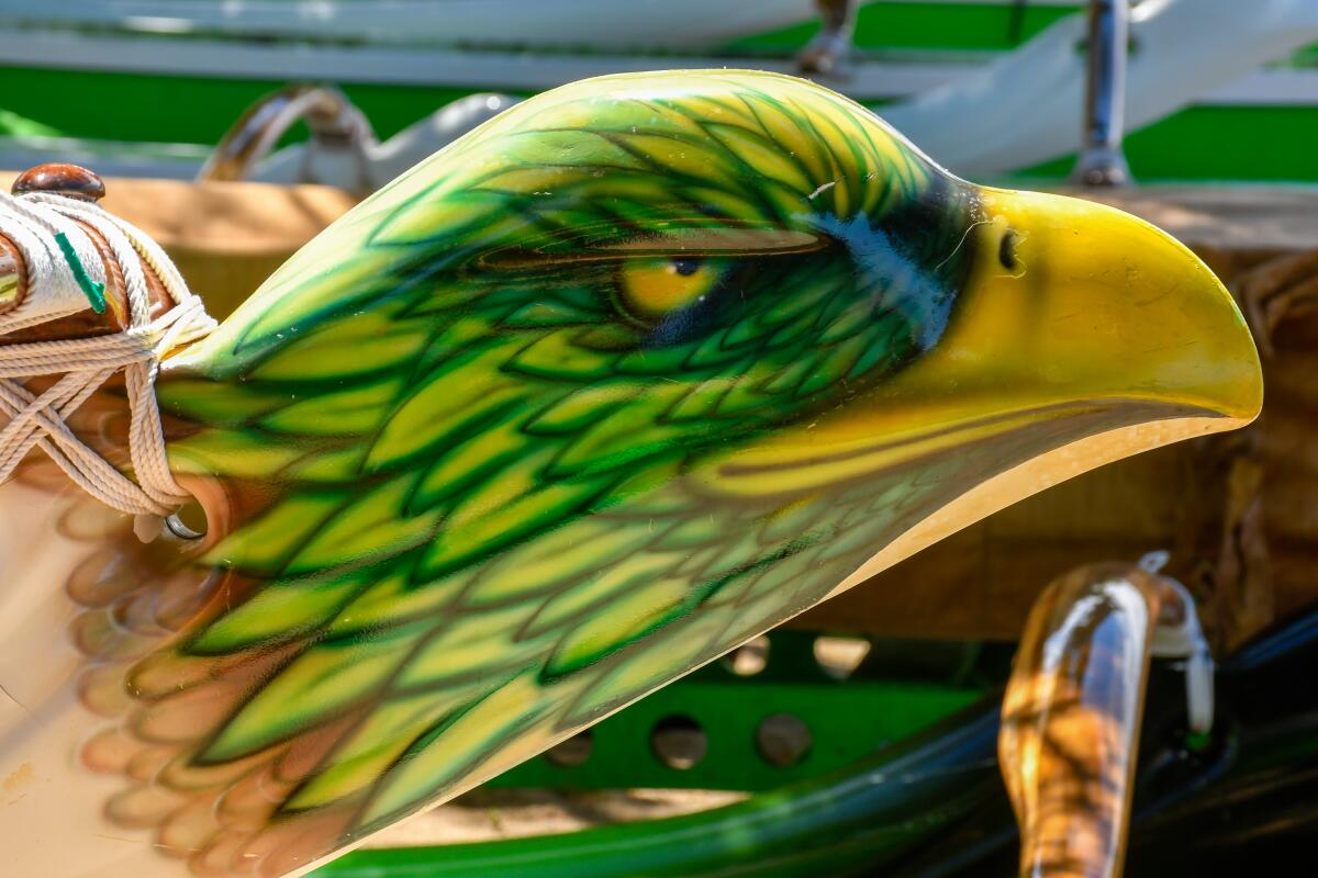 Custom paint job of a bird's head on an outrigger canoe