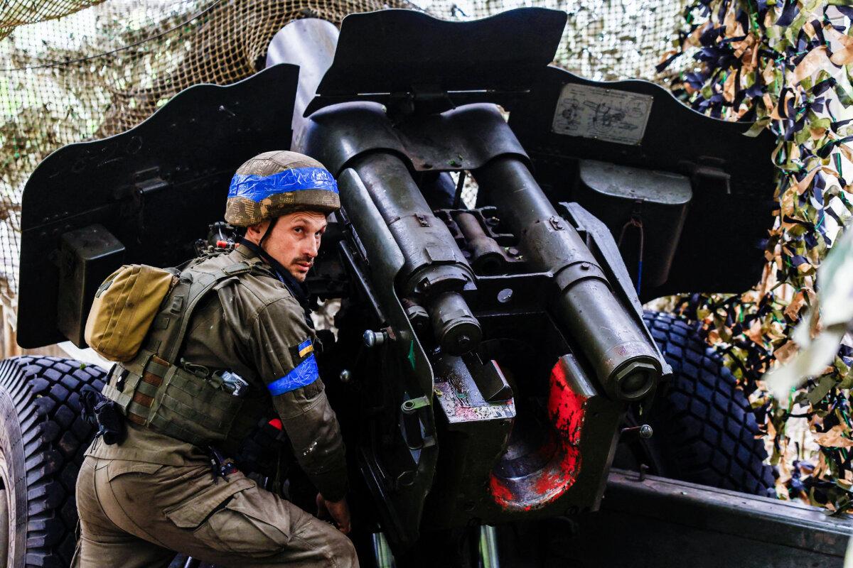 A Ukrainian artilleryman mans a howitzer near Ukraine's Kharkiv region, on May 21, 2024. (Valentyn Ogirenko/Reuters)