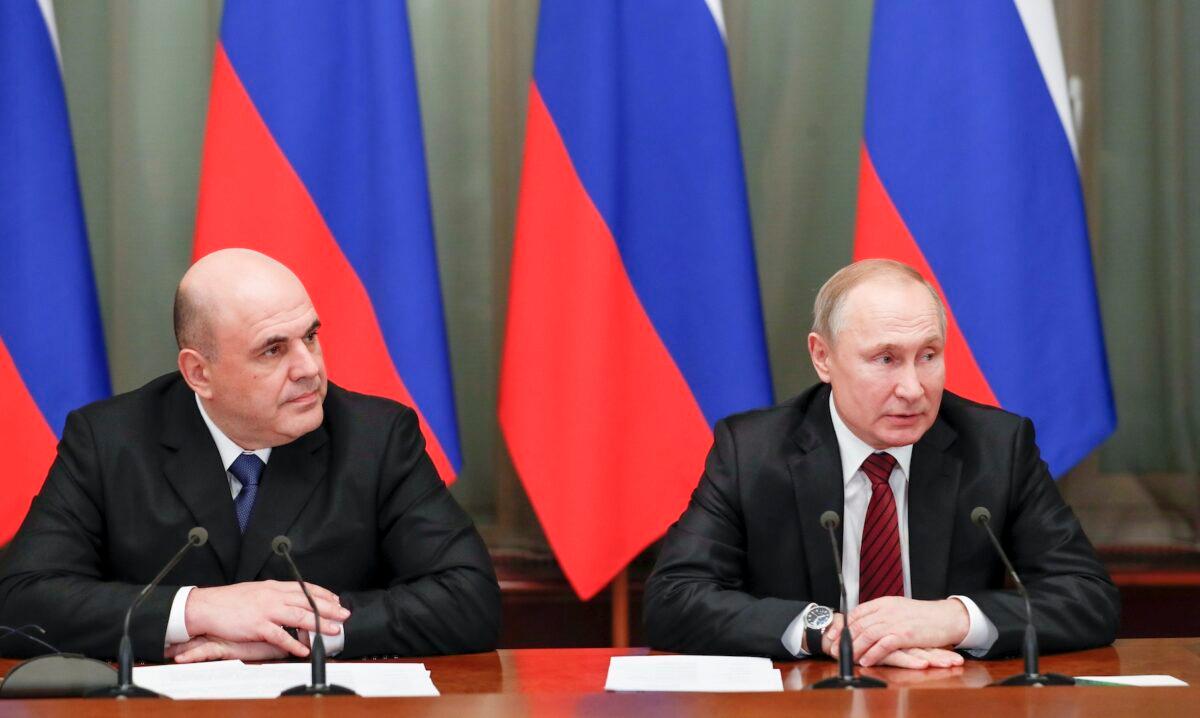 Russian President Vladimir Putin (R) and new Russian Prime Minister Mikhail Mishustin (L) attend a cabinet meeting in Moscow, Russia, on Jan. 21, 2020. (Dmitry Astakhov, Sputnik, Government Pool Photo via AP)