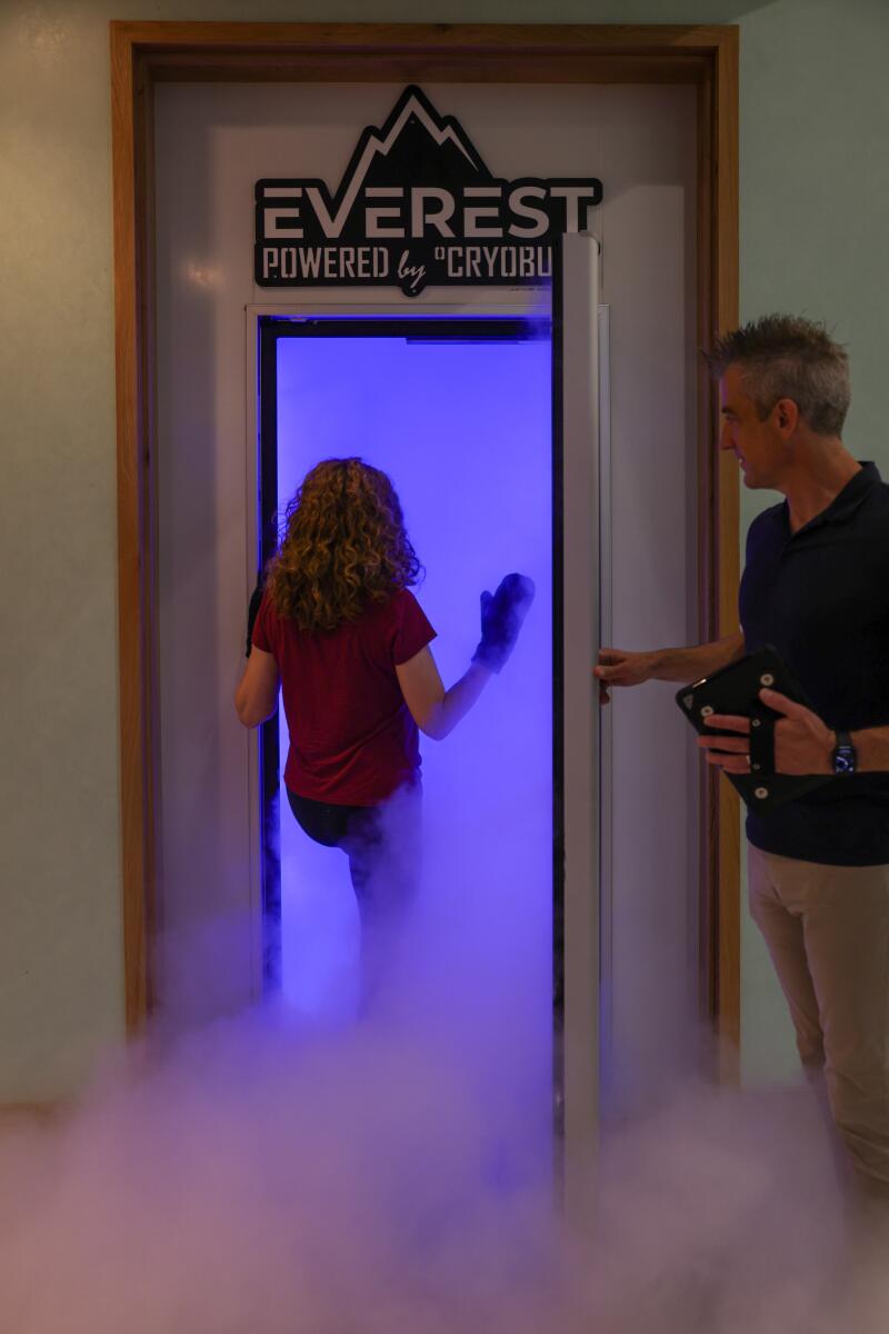 Cold vapor billows out of a cryotherapy chamber as the author steps in.