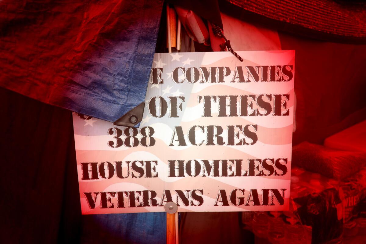 A sign in support of housing homeless vets rests outside a tent on Veterans Row 