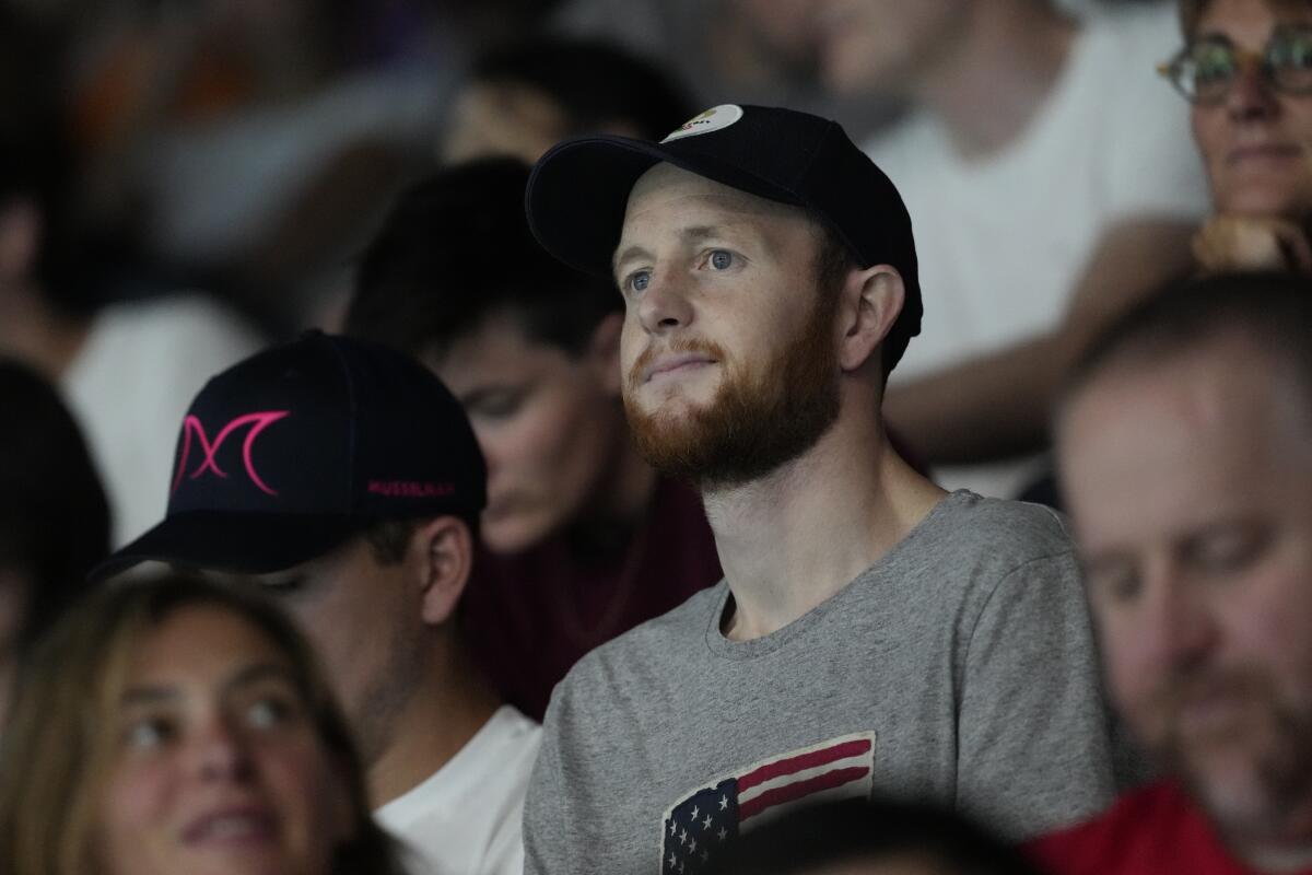 Pat Woepse, center, husband of the U.S. player Maddie Musselman, watches a match on July 27.