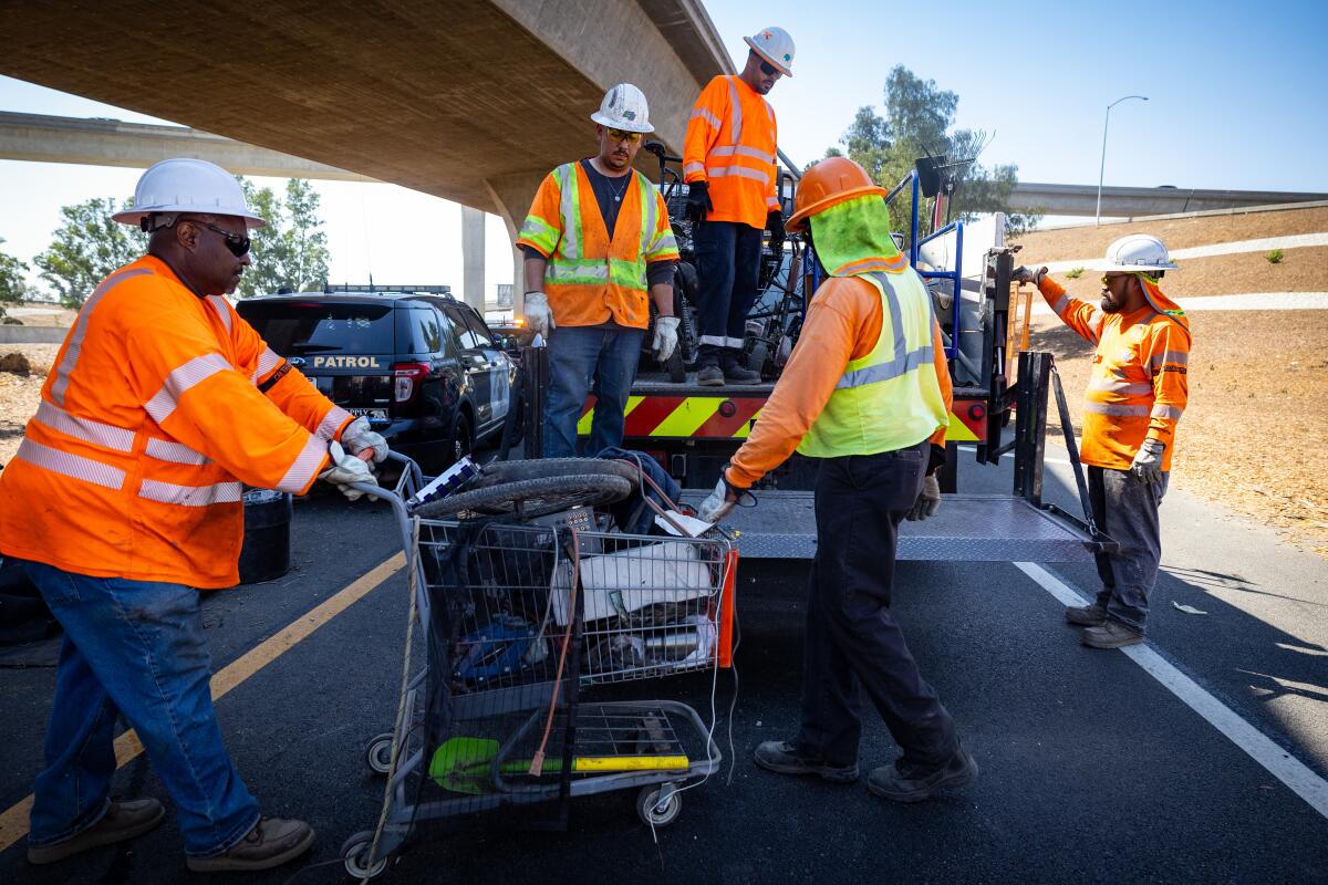 Governor Gavin Newsom along with Caltrans clean up an encampment site near Paxton Street and Remick Avenue in Los Angeles.