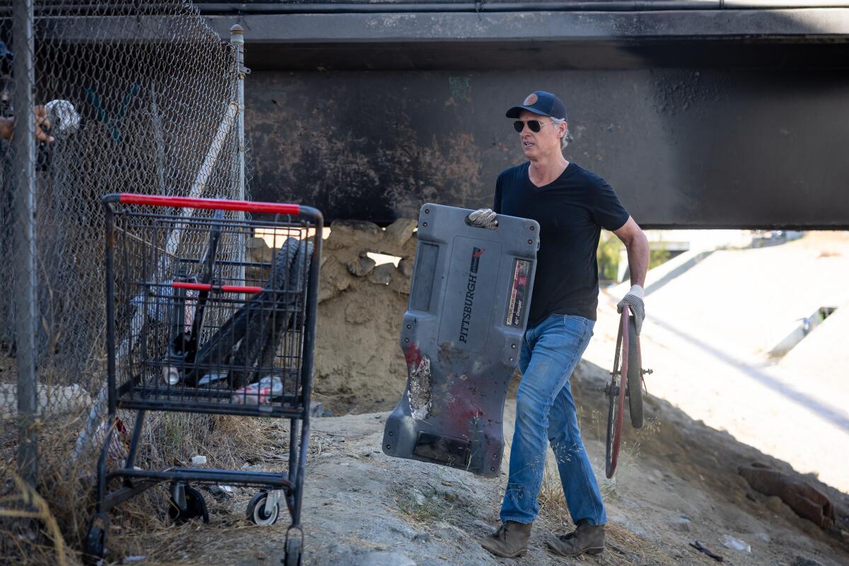 Governor Gavin Newsom along with Caltrans clean up an encampment site near Paxton Street and Remick Avenue in Los Angeles