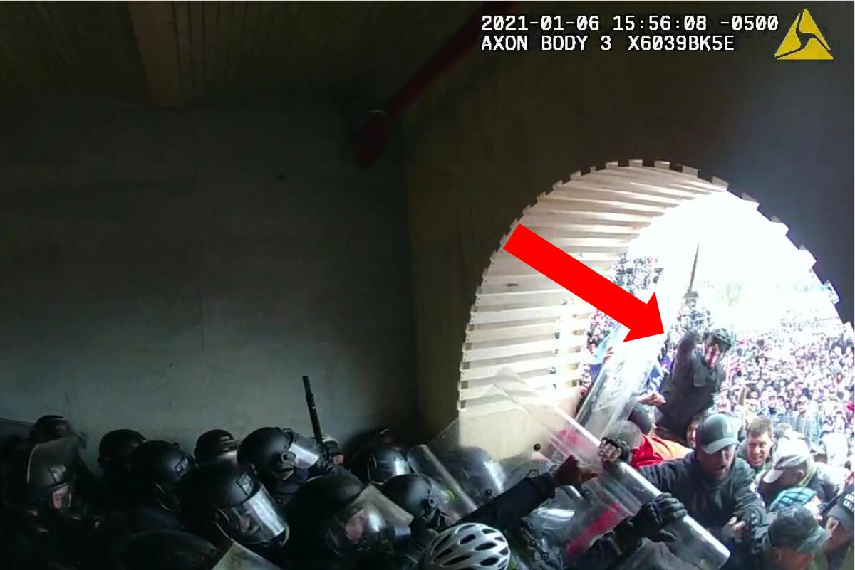 A screengrab from video has a red arrow pointing to David Nicholas Dempsey in a rioting crowd