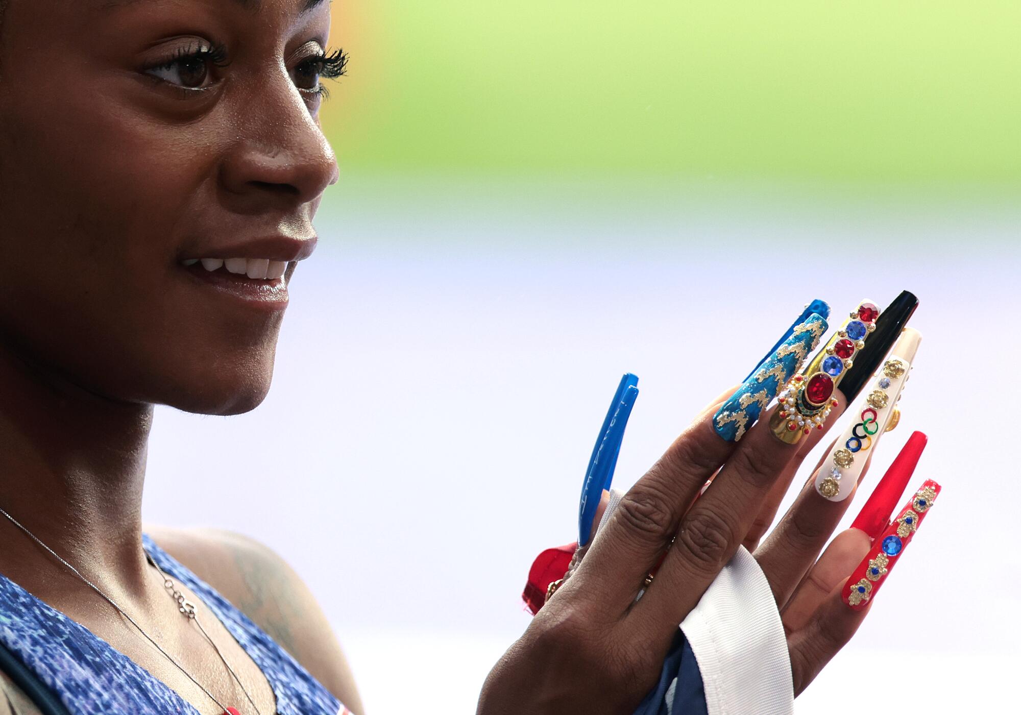 USA's Sha'carri Richardson sports her long nails after winning gold in the 4X100 relay at th