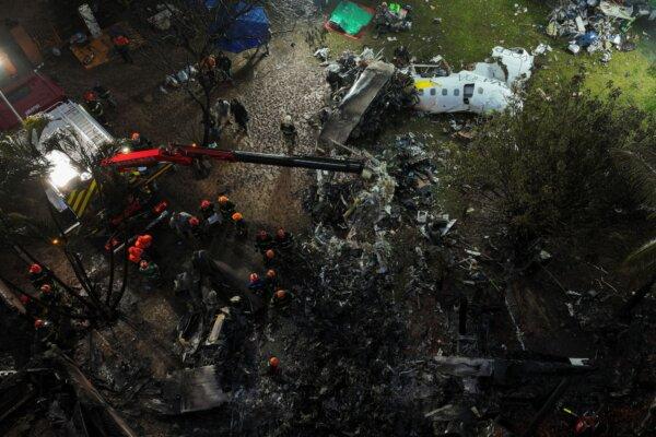 Firefighters and rescue workers work in the debris at the site where an airplane with 61 people on board crashed in Vinhedo, Sao Paulo state, Brazil, on Aug. 10, 2024. (Andre Penner/AP Photo)