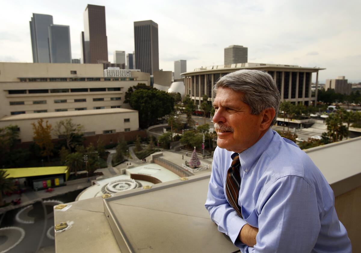 Zev Yaroslavsky leans against a balcony overlooking the city.