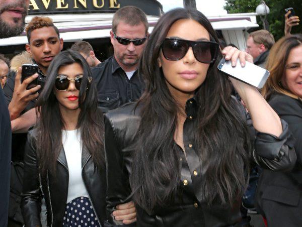 Kim Kardashian (R) and Kourtney Kardashian (L) leave a restaurant in Paris on May 22, 2014 (Jacques Brinon/AP Photo)