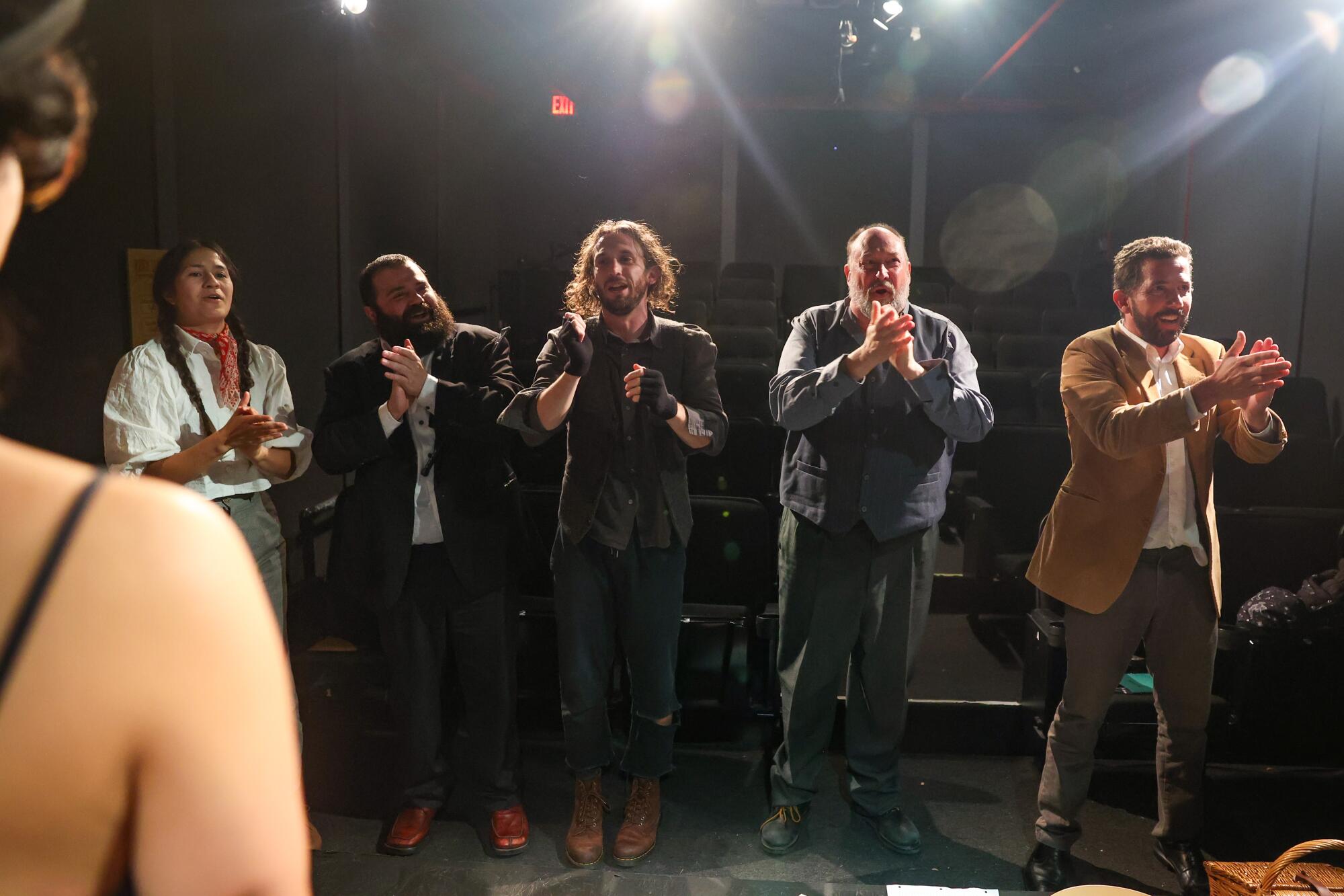 "Escape from Godot" actors clap for the audience at the end of the play.