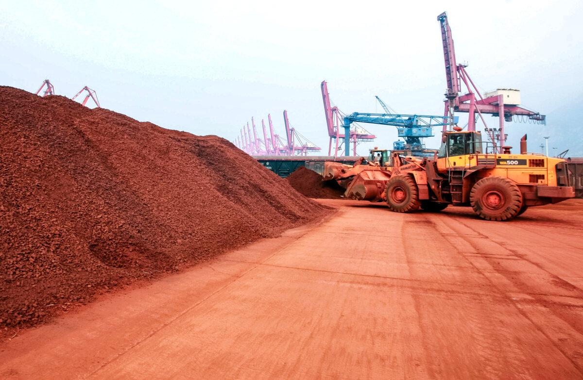 A loader shifts soil containing rare-earth minerals at a port in Lianyungang, Jiangsu Province, China, on Sept. 5, 2010. (STR/AFP via Getty Images)