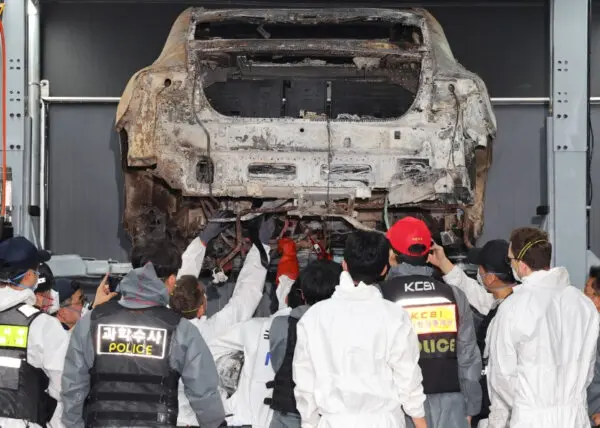 Officials from police, fire, National Forensic Service and Mercedes-Benz conduct a second joint forensic examination of an electric car that caught fire in the underground parking lot of an apartment complex on Aug. 1 in Incheon, South Korea on Aug. 8, 2024. (Yonhap via Reuters)